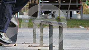 Skater make trick nollie lipslide on rail in skatepark, close-up view slowmotion