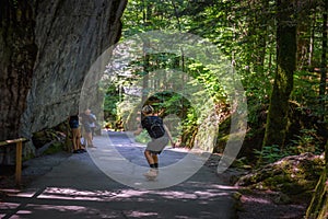 Skater riding a skateboard on a road towards the Blausee Lake in Switzerland