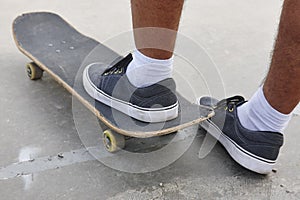 Skater and skateboard legs detail. Lifestyle urban background