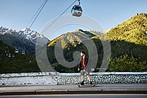 Skater traveling in the mountains on his longboard