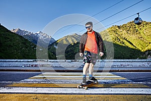 Skater traveling in the mountains on his longboard