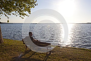 Skater watching a sunset sitted in a bench