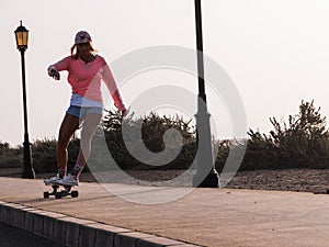 Skater woman on surfskate outdoors