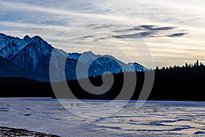 Skaters on Johnson Lake. Banff National Park, Alberta, Canada