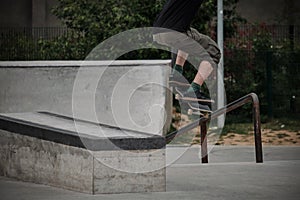 Skaters performing trick in pubblic park doing a Ollie down the stairs