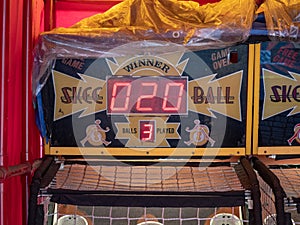 Skee ball arcade game sitting in tent outdoors with a score of 20