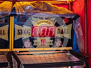 Skee ball arcade game station wrapped in a plastic in storage