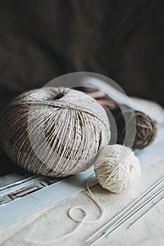 Skein and balls of woolen yarn and knitting needles for hand knitting