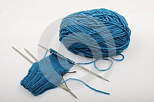 Skein of blue wool and knitting needls