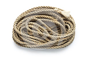 A skein of old natural rope on a white background.