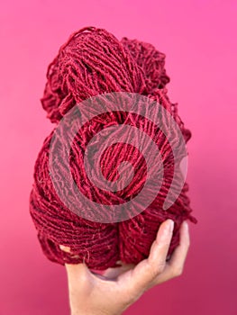 Skein of red yarn dyed with natural dyes of Cochineal insects photo