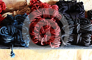 Skeins of 6mm diameter jute rope for Japanese bondage and shibari. Blue, red, black and undyed ropes at the bdsm fair at