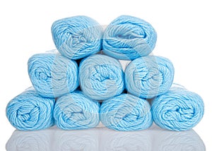 Skeins of powder blue yarn stacked partial pyramid shape isolated on white