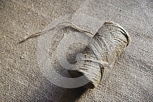 Skeins of thread on burlap. Yellow threads on coarse cloth