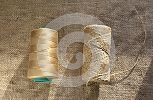 Skeins of thread on burlap. Yellow threads on coarse cloth