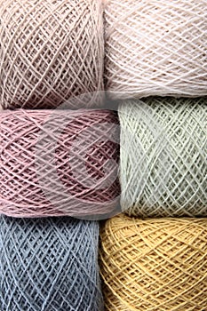 Skeins of yarn for knitting as a background. Multicolored threads. A set of colored cotton yarn. The concept of a hobby