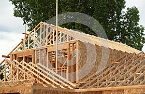 The skeletal walls and trusses of a new home. photo