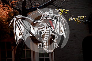 Skeleton Demon Dragon blowup Halloween yard art - hanging from tree - long red tongue - evil photo