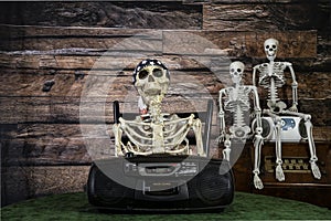 skeleton family listening to music on retro boom box