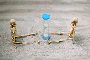 Skeleton figures and hourglass