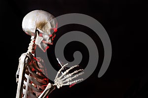 Skeleton holding an ecigarette with danger red highlights ready to vape