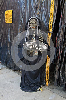 Skeleton hostess outside haunted house