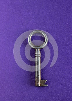 Skeleton key on textured purple background