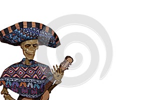 Skeleton Mariachi player with poncho and hat and guitar - Halloween decoration - on side of blank white image - room for copy