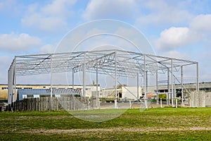 Skeleton of metal building under construction, industrial object