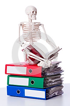 Skeleton with pile of files