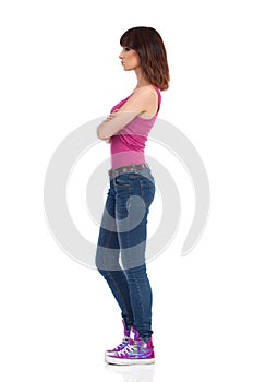 Skeptic Woman Is Standing With Arms Crossed. Side View