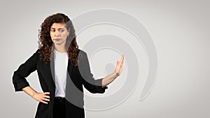 Skeptical businesswoman with hand gesture