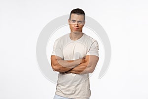 Skeptical and judgemental serious-looking handsome strong man with huge biceps, cross arms over chest defensive photo