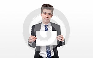 Skeptical man with blank paper in studio