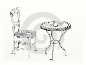Sketch of a chair and table on a white background.