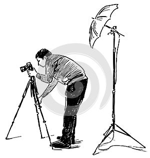 Sketch of professional photographer with camera on tripod and lighting equipment at work