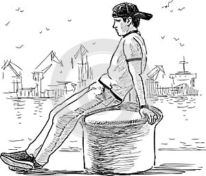 Sketch of young man sitting on bollard on seafront in port and dreaming
