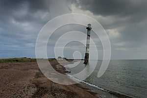 Skew lighthouse in the Baltic Sea. Stormy night on the beach. Kiipsaar, Harilaid, Saaremaa, Estonia, Europe.