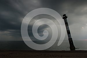 Skew lighthouse in the Baltic Sea. Stormy night on the beach. Kiipsaar, Harilaid, Saaremaa, Estonia, Europe. photo