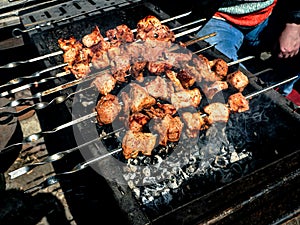 Skewers with meat are fried over the coals