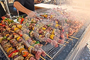 Skewers of mixed meats and vegetables cooked on the grill.