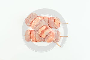 Skewers from raw chicken leg meat without skin for a supermarket on a white background.Food for retail.Chicken skewers