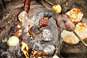 Skewers rosting on camp fire.