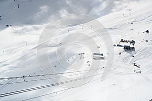 Ski area in the snow on the zugspitze glacier with lift, cable car and slopes in the alps between germany and austria near