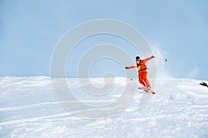 Ski athlete in a fresh snow powder rushes down the snow slope