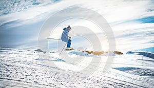 Ski athlete performing acrobatic jump on downhill at sunset - Adult skier riding down for winter time in ski slope - Extreme snow