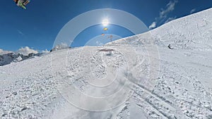 A ski beginner making a selfie video while skiing downhills.