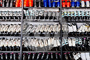 Ski boots and ice skates on shelf