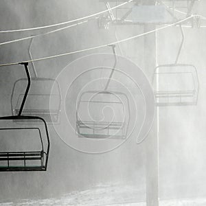 Ski chair lift climbing up snowy ski slope