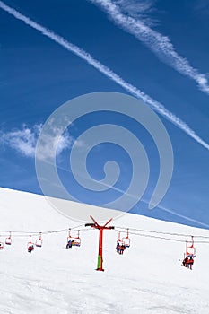 Ski chair with people in ski resort